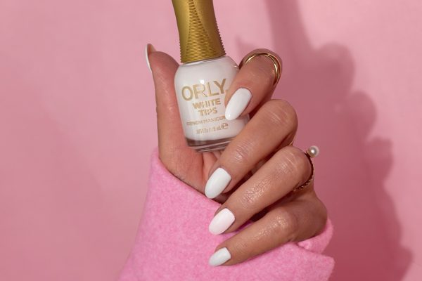 orly hand holding white tips varnish