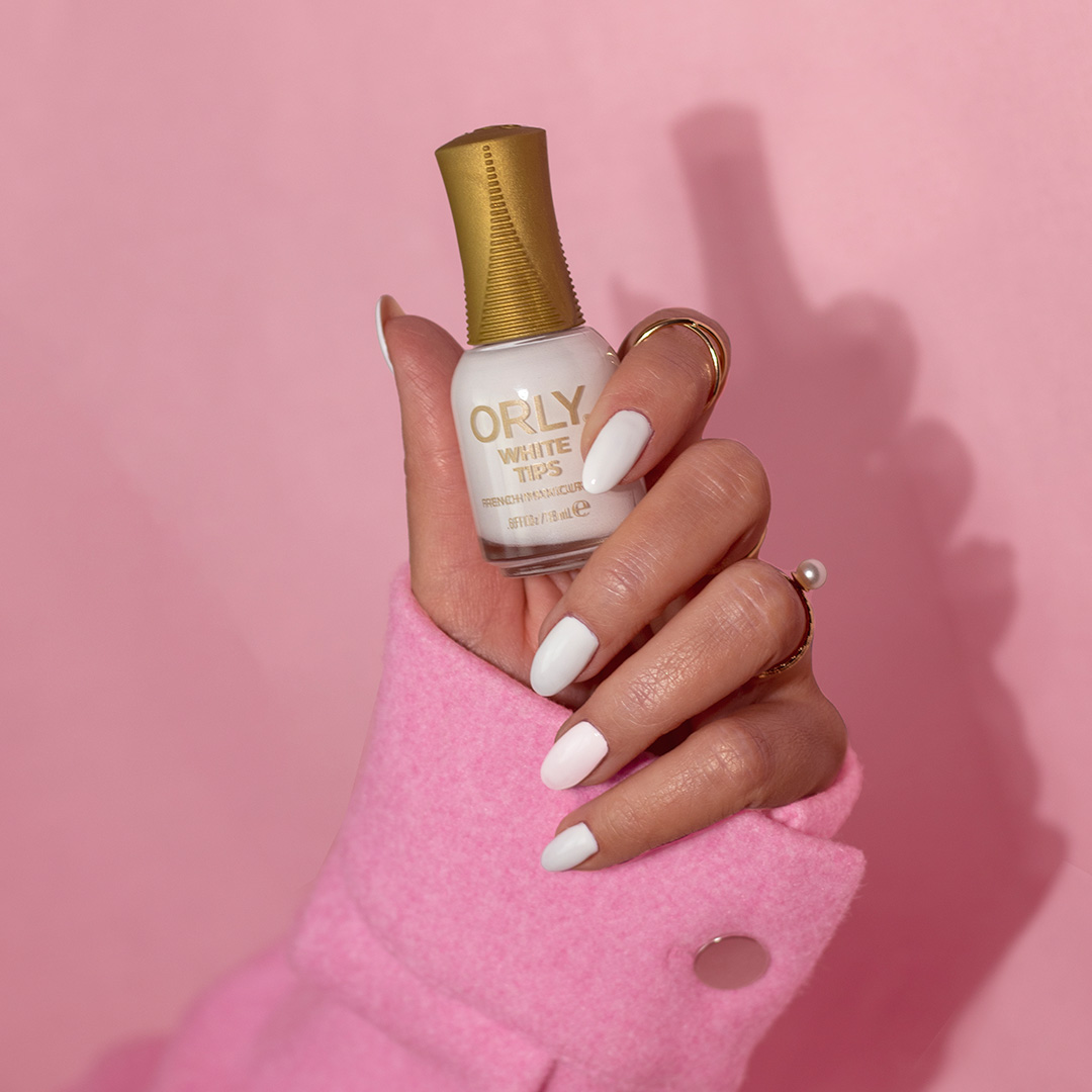 orly hand holding white tips varnish